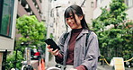 Woman, phone and bicycle in city for text, location and travel with social media, commute and funny. Asian person, mobile and bike in urban town for eco friendly transport, app and laughing in Japan