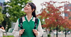 Japanese, woman and smile with walking in city, travel journey and adventure with expression outdoor. Urban, female person and tourist with commute for destination, location and amazed girl in Tokyo