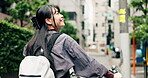 Woman, happy and bicycle in city for travel, location and building with adventure, commute or trip. Asian person, riding and bike in urban town for eco friendly transport, walking or morning in Japan