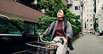 Woman, riding and bicycle in city for commute, location and positive with joy, travel and trip. Asian person, happy and bike in urban town for eco friendly transport, exercise or morning in Japan 