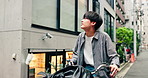 Japanese man, bike and delivery in city with thinking, smile and search for direction with eco friendly travel. Person, courier and bicycle on street with check for location, happy and bag on road