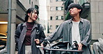 Couple, talking and walking with bicycle in city for morning commute, urban journey and bonding. Japanese people, happy and together with bike on sidewalk in town for travel, conversation and support