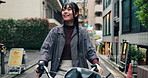 Japanese woman, happy and bike for travel in city for thinking, reflection or search for location on journey. Person, bicycle and tourism with check, direction or eco friendly transport on urban road