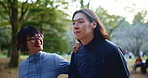 Japanese couple, walking and date outdoor, bonding and smile together with happy partner on vacation. Asian man, woman and relationship at park for travel, support and romantic connection for love