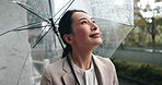 Rain, city and Japanese woman with umbrella and professional on morning commute in winter. View, outdoor and cold weather on urban street with water drops, travel and Tokyo trip in storm with smile