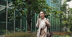 Phone call, walking and woman in office park with business discussion, contact and morning commute. City, building and Japanese businesswoman with smartphone, outdoor communication and urban travel