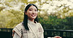 Walking, thinking or Asian woman in park with smile or fashion in Japan culture for tourism. Girl, face or happy Japanese person in urban town for travel or sightseeing on outdoor holiday adventure