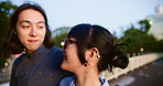 Japanese couple, travel and talking in city, wind and bonding together with happy partner on date. Asian man, woman and relationship outdoor on bridge for support, walking and connection for love