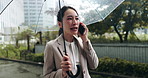 Talking, phone call and woman in city with umbrella, business discussion and morning commute in winter. Rain, cover and Japanese businesswoman with smartphone, communication or urban travel on street