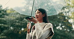 Rain, smartphone and woman with umbrella, talking and communication for taxi, voice note and nature. Outdoor, speaker and discussion with mobile, park and happy person  with app, chat and Japan