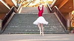 Woman, ballet and dancer with spin in city by stairs with steps, balance and rhythm in street. Person, dancing and smile for art with elegance, concert and port de bras on urban sidewalk in Japan