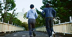 Back, fitness and people in city for running, wellness and cardio exercise in Japan. Asian couple, training and racing on Tokyo bridge for commitment, healthy relationship and support for growth