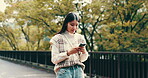 Happy woman, phone and typing in Japan for communication, text message and social media with app. Female person, mobile and online outdoor for email, notification and walking with internet or website