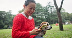Japan, dog and woman in park, smartphone and typing with happiness, funny meme and connection. Asian person, outdoor and girl with pet, cellphone and message to contact, network and communication