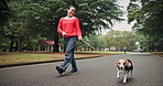Asian woman, dog and walking with leash at park for bonding, animal care or love on road, path or street. Japanese, female person and pet owner with canine for travel, stroll or fresh air in nature