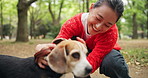 Woman, dog and happy for play at park, care and love with connection, excited and bonding in nature. Person, animal or pet beagle puppy with stroke, loyalty and training with trust on path in Japan