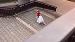 Ballerina, dancer and Asian woman in city on stairs for performance, dancing and practice in town. Creative art, entertainment and person in Japan for ballet movement, balance and artistic talent