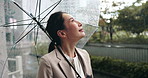 Rain, city view and Japanese woman with umbrella and professional on morning commute in winter. Job, outdoor and cold weather on street with water drops, travel and Tokyo trip in storm with smile