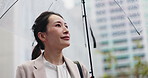 Rain, urban and Japanese woman with umbrella and professional on morning commute in winter. Thinking, outdoor and cold weather on city street with worker, travel and Tokyo trip in storm with wait
