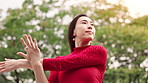 Ballet, dancer and Asian woman in nature stretching for performance, dancing and practice. Creative, entertainment and Japanese ballerina warm up for movement, balance and artistic talent in park