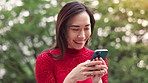 Woman, phone and happy for texting in park with reading, excited or laugh at funny meme on mobile app. Person, smartphone and smile in spring with comic post, video or chat on social media in Japan
