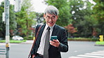 Business man, phone and texting in city on travel, contact and scroll with smile on mobile app. Mature person, outdoor and smartphone on commute to workplace with notification, chat or email in Japan