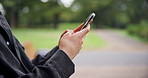 Man, hands and typing with phone on park bench for communication, online chatting or texting in nature. Japanese, closeup or male person on mobile smartphone for network, travel app or location