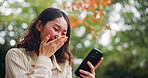 Japan, funny and woman on bench, cellphone and joy with meme, social media and network. Asian girl, outdoor and person in park, smartphone and joke with humor, laughing and break with digital app