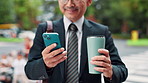 Phone, coffee and business Asian man in city for social media, internet and location on commute. Professional, corporate and mature Japanese person on smartphone for contact, online email and website