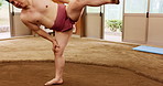 Leg, sumo and wrestling with Japanese man in arena for training, shiko ritual and tournament. Festival, competition and game with asian person in dohyo ring of temple for culture, fight and sports.