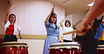 Music, drums and instrument with women in studio for class, performance or practice. Traditional Japanese art, taiko band and sound with bachi, demonstration and talent for percussion teaching
