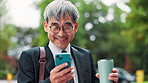 Smartphone, coffee and business Asian man in city for social media, internet and chatting. Professional travel, corporate and mature Japanese person on phone for contact, online email and website