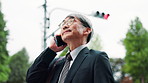 Phone call, talking and business Asian man in city for contact on commute, travel and trip. Professional, corporate and mature Japanese person on smartphone for communication, networking and chat
