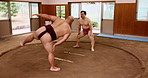 Training, sumo wrestling and stretching with practice in ring for match fitness, traditional exercise and warm up. Japanese people, man and instructor with squats for flexibility workout and shiko