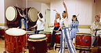 Music, drums and group of Japanese women in class for movement, performance or practice. Traditional art, taiko band and creative sound with bachi, demonstration or talent for percussion teaching