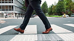 Businessman, legs and crossing street in city for travel, journey and morning commute to work. Japanese person, feet and walking route on Tokyo road with commitment, steps and eco conscious employee