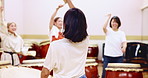 Japanese music, drums and group of women in practice for movement, performance or class. Traditional art, taiko band and teacher back with bachi, demonstration or talent for creative percussion sound
