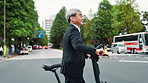 Electric bike, walking and businessman in city for travel to work in morning with sustainable transport. Professional, bicycle and mature male lawyer commuting in town for corporate career in Japan.