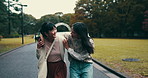 Asian women, hug or friends in park with surprise for bonding together, walking or funny joke. Happy people, phone and Japanese girls in nature or garden for embrace, laughing and travel in Japan