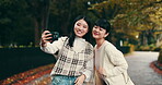 Japanese women, friends and selfie for memory, playful or social media app with peace sign. Female people, happiness and smile as post for bonding together, relax or outdoor in park, garden or nature