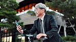 Business man, phone and electric bike in city, travel or reading on mobile app for direction in street. Mature person, smartphone and eco friendly transport with check, location and commute in Japan