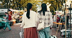 Travel, festival and back of Japanese people in market for culture holiday, traditional celebration and tourism. Street vendor, spring season and vacation with asian friends walking with suitcase