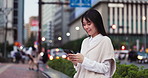 Japanese woman, city and typing with smartphone for social media, mobile notification and communication by road. Commuter, phone and search online for travel break, location or urban street of Tokyo