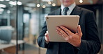 Hands, tablet and business man in office with typing in corridor, scroll and application by window at company. Japanese person, touchscreen and review with feedback for project at insurance agency