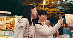 Friends, selfie and happy for street market, bonding and social media with celebration in Japan at night together. Women, memory and outdoor in Tokyo for culture, festival and community with travel