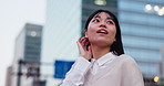 Travel, wow and woman in city with buildings, smile and outdoor evening with low angle. Discover, explore and excited Japanese girl thinking in street on urban adventure, commute or happy opportunity