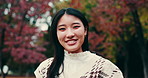 Face, smile and Japanese woman in park, trees and happiness with confidence, fashion and trees. Portrait, Asian person and girl in stylish clothes, environment and countryside with plants and joyful