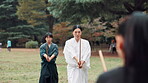 Aikido, bamboo and sword with Japanese people in forest for martial arts exercise, technique or training. Bokken, culture and fitness with Sensei teaching students in nature for practice or skill
