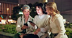 Mobile, city friends and group of students on social media, research or learning at night in Japan. College, phone and Asian people together on chat app online, talking and check assignment deadline