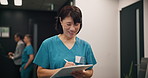 Happy, asian woman or nurse walking with clipboard at hospital for patient report, result or application. Japanese, female person or healthcare employee writing with document for medical prescription